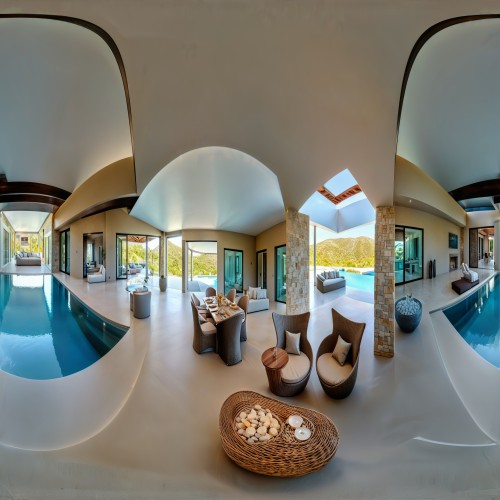 A contemporary luxury villa living room with an indoor-outdoor concept, showcasing neutral tones, designer furniture, and a seamless flow to the infinity pool outside.